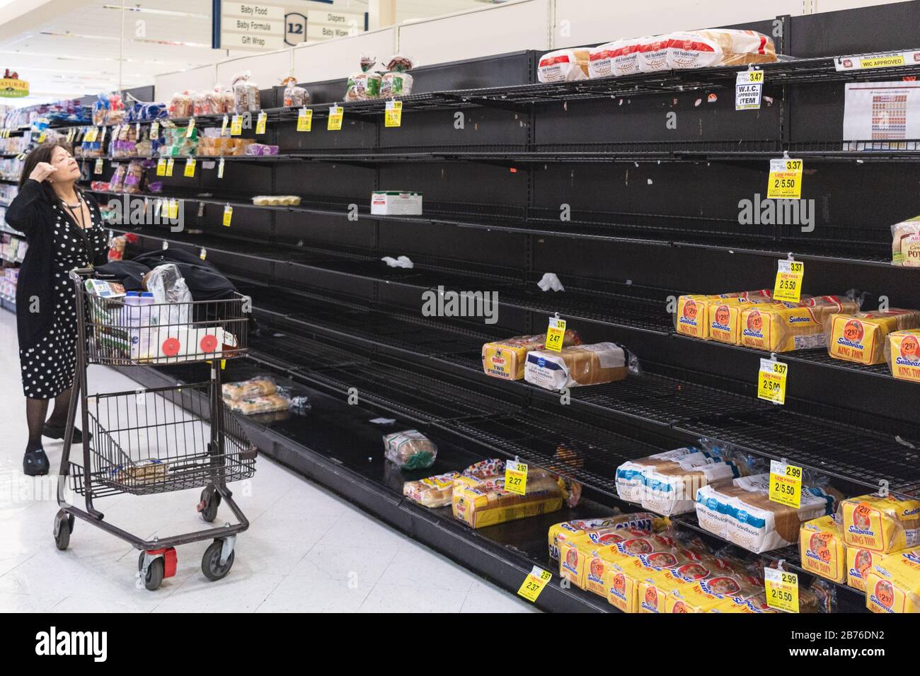 Asheville, USA, 13th Mar 2020. A shopper surveys the bread aisle during