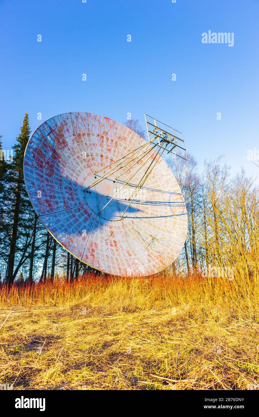 large radio astronomy telescope antenna in the forest broadcast signal  Stock Photo
