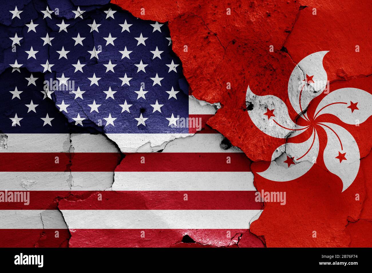 flags of USA and Hong Kong painted on cracked wall Stock Photo