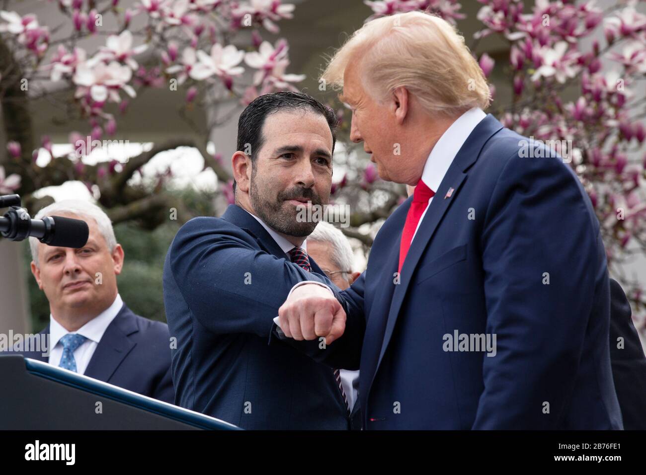 Washington, DC, USA. 13th Mar, 2020. United States President Donald J. Trump, right, bumps elbows with Bruce Greenstein, Executive Vice President and Chief Strategy and Innovation Officer at LHC Group during a news conference in the Rose Garden at the White House in Washington, DC, U.S., on Friday, March 13, 2020. Trump announced that he will be declaring a national emergency in response to the Coronavirus. Credit: Stefani Reynolds/CNP | usage worldwide Credit: dpa/Alamy Live News Stock Photo