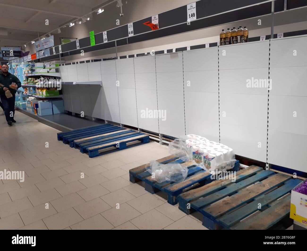 Bare shelves where toilet rolls are normally stocked, with only a few