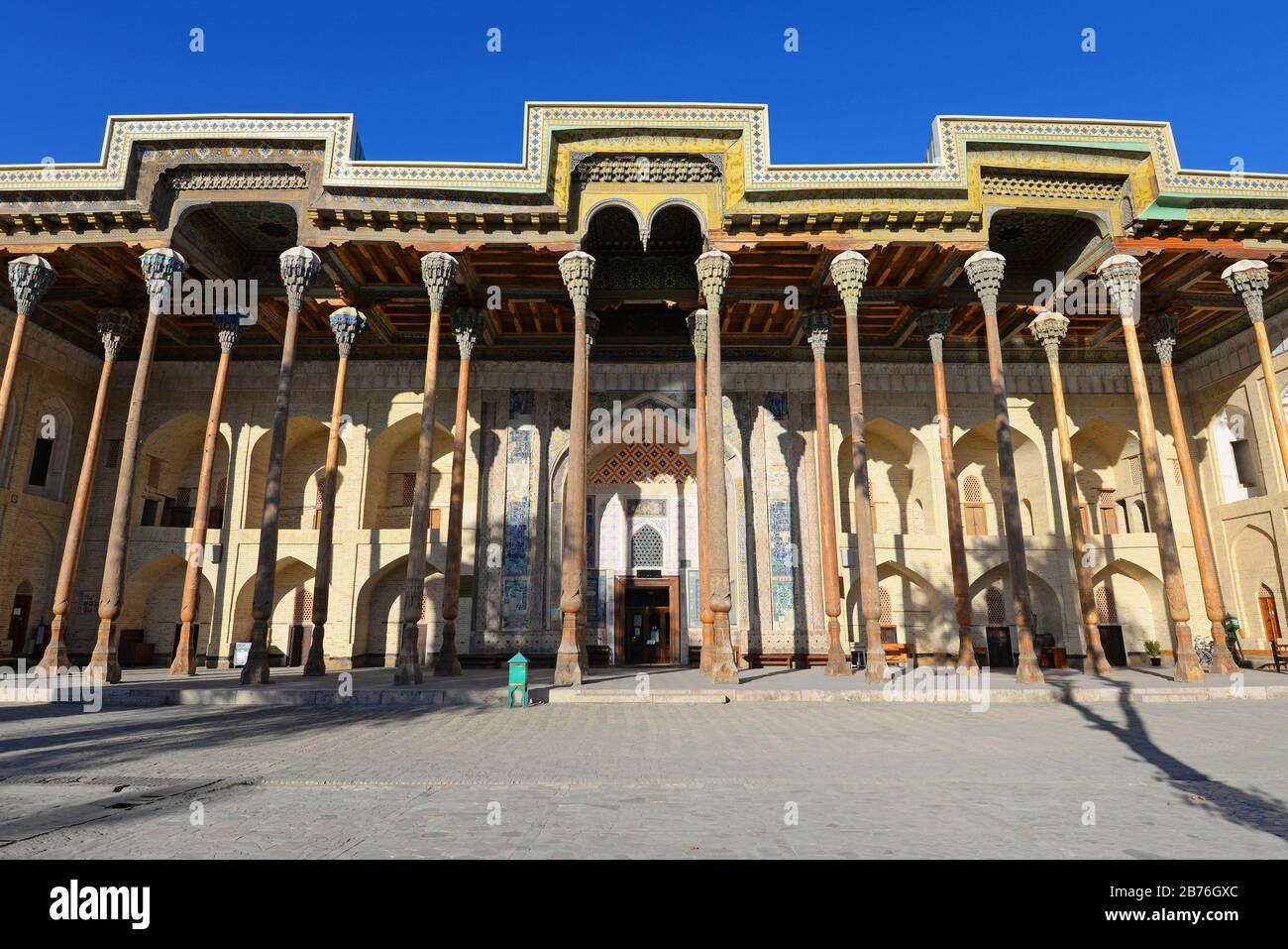 Frontal view of Bolo Haouz Mosque, a historical mosque located in Bukhara, Uzbekistan built with wooden columns, bricks and ornamented with mosaics. Stock Photo