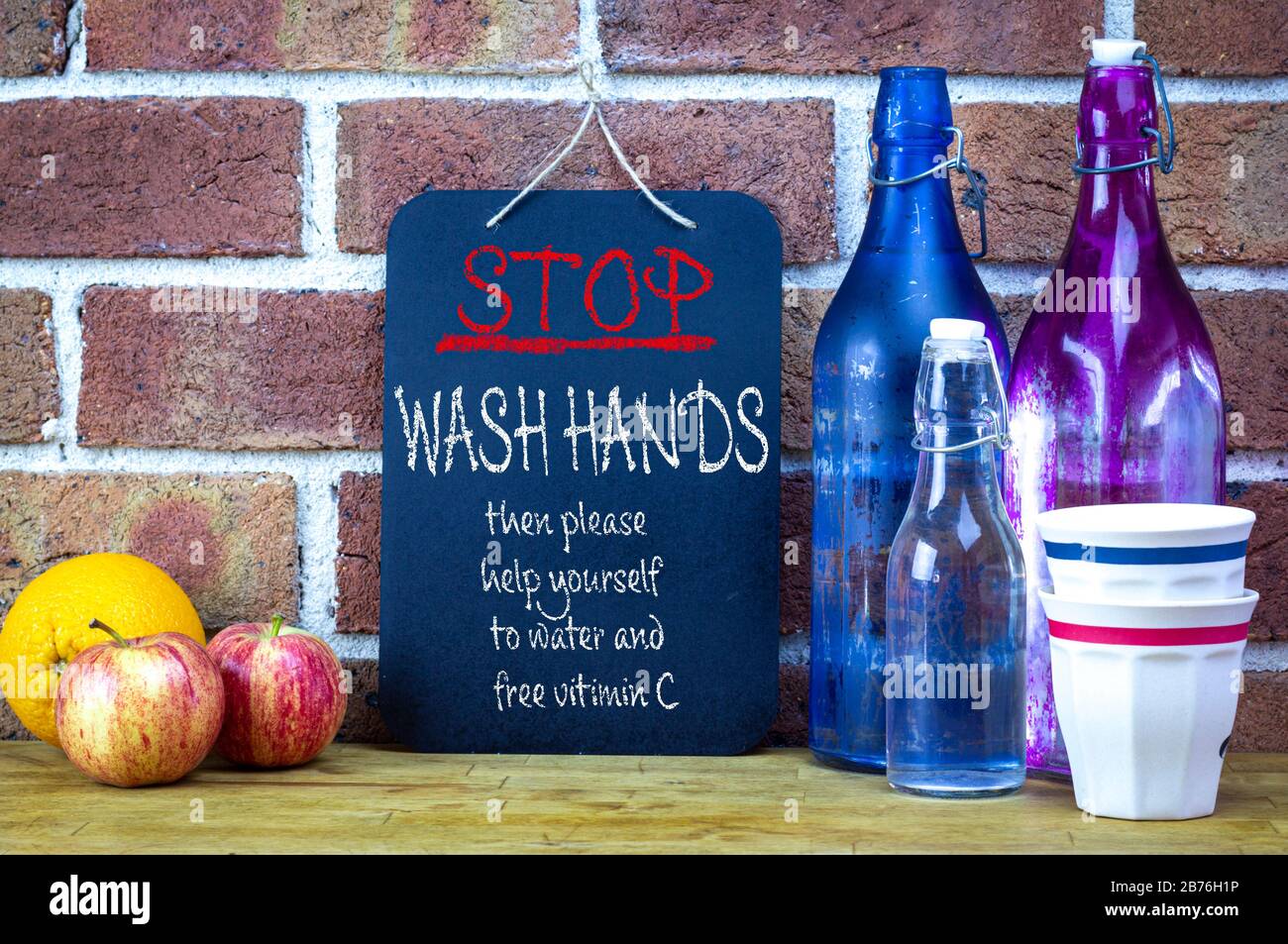 Cafe sign, stop wash hands then help yourself to water and vitamin C, community coronavirus covid19 spreading prevention Stock Photo