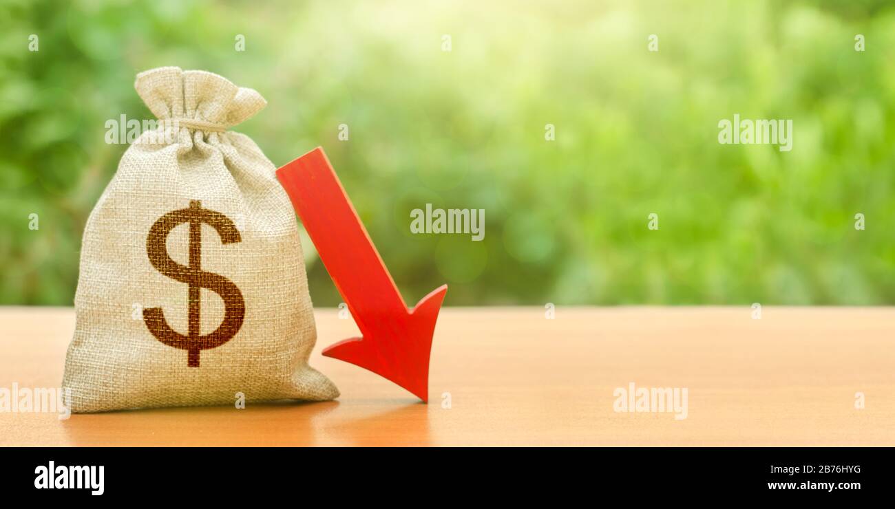 Dollar money bag and red arrow down. Economic decline. Depreciation of national currency. Devaluation. Crisis and economic shock. Discount rate reduct Stock Photo