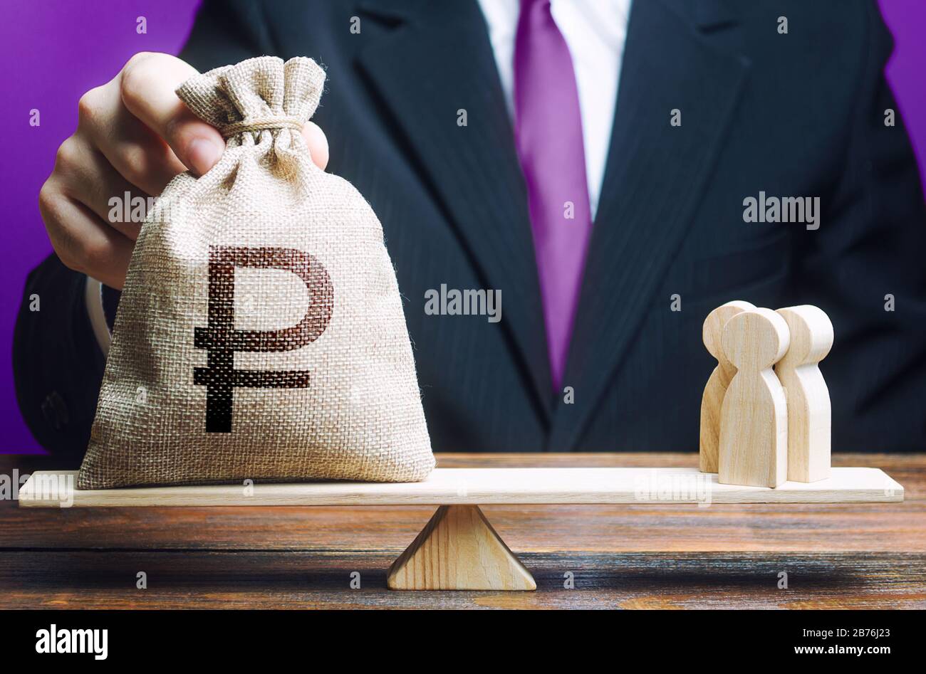 Businessman puts russian ruble money bag and people on scales. Hiring recruiting workers, staff specialists. Remuneration and repayment of wage arrear Stock Photo