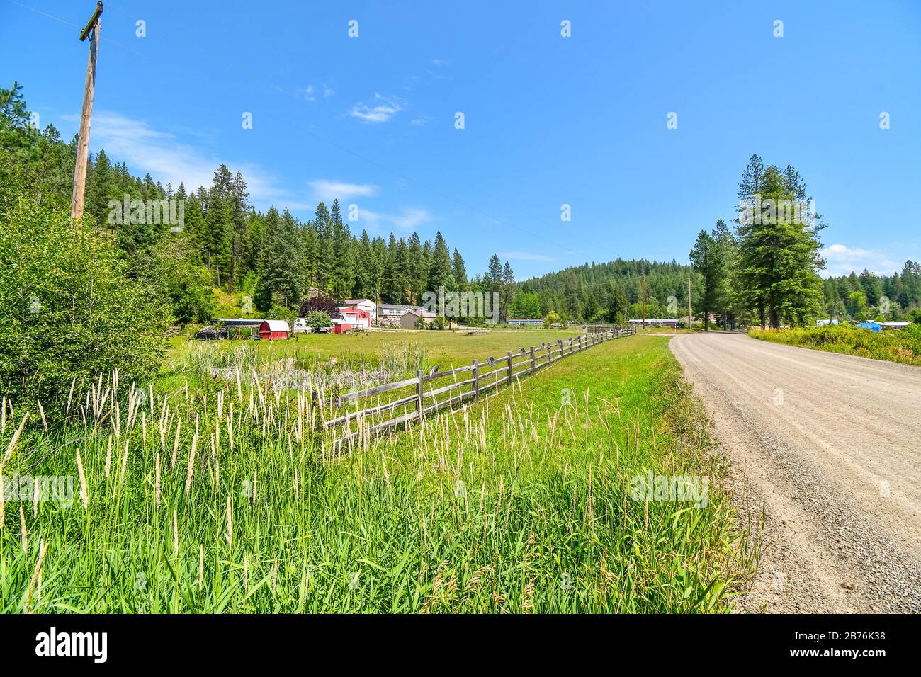 A dirt rural with homes and ranches in the rural Coeur d'Alene area of North Idaho, USA Stock Photo