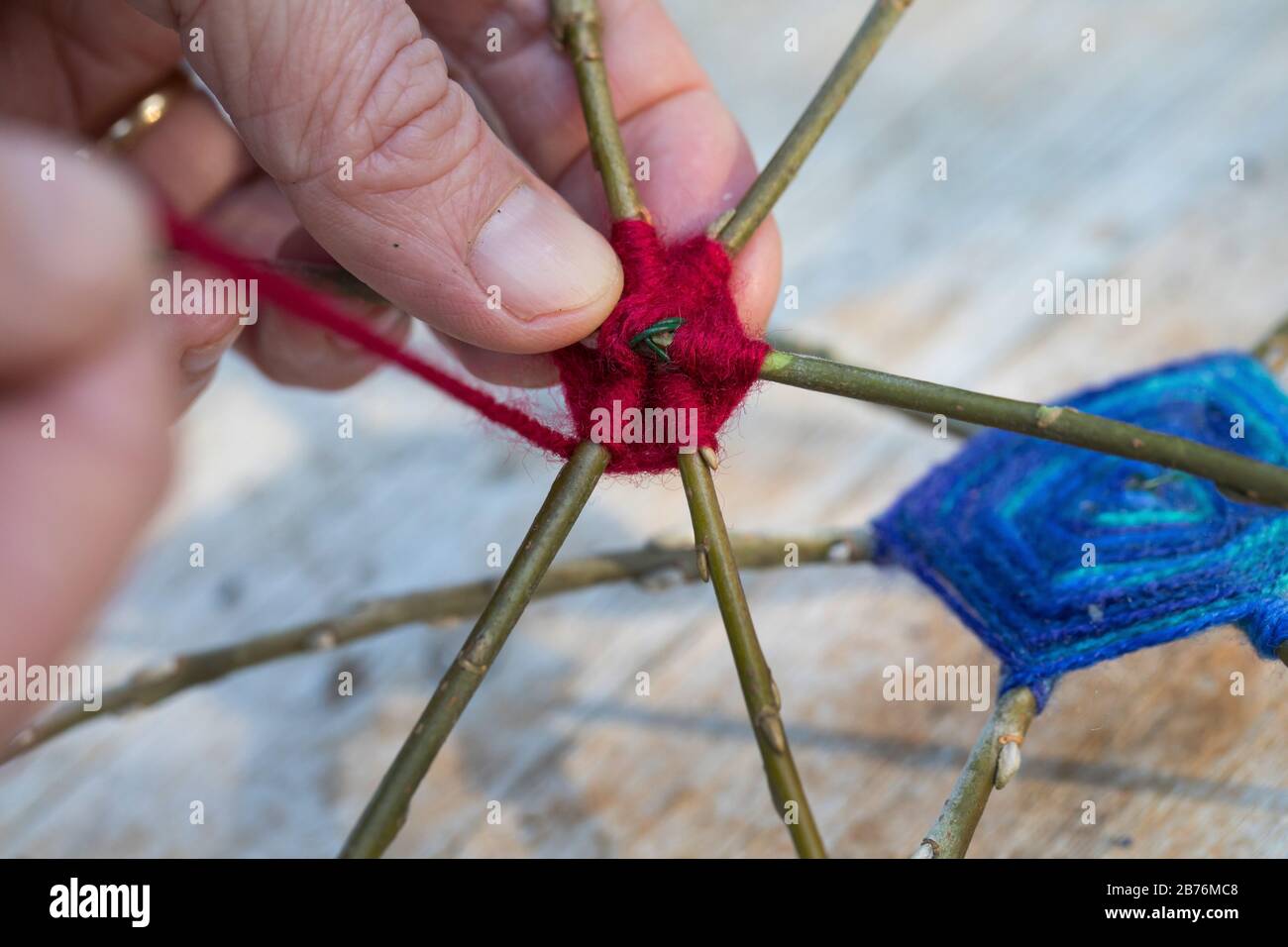 making a keeper vor a fat ball with willow twigs, wool and wire, series picture 5/10, Germany Stock Photo