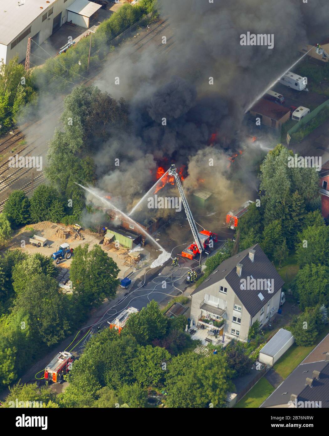 fire extinguishing work on a destroyed by the fire goods depot in Hagen-Haspe, 07.07.2012, aerial view, Germany, North Rhine-Westphalia, Ruhr Area, Hagen Stock Photo