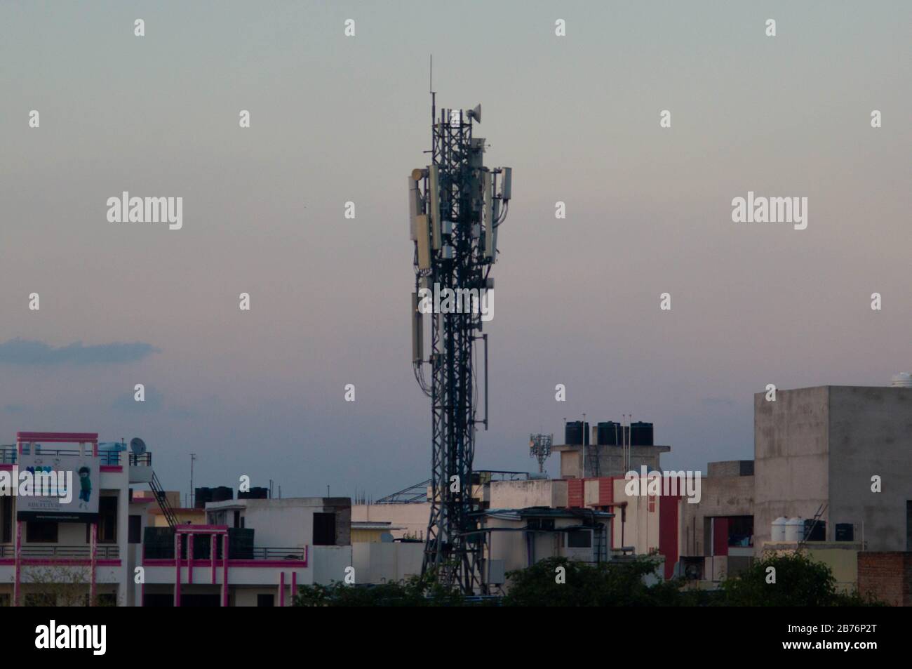 Jaipur, India, Circa 2020 - Photograph of a telephone tower situated in the middle of a residential area. The tower is made of metal and is used to bo Stock Photo