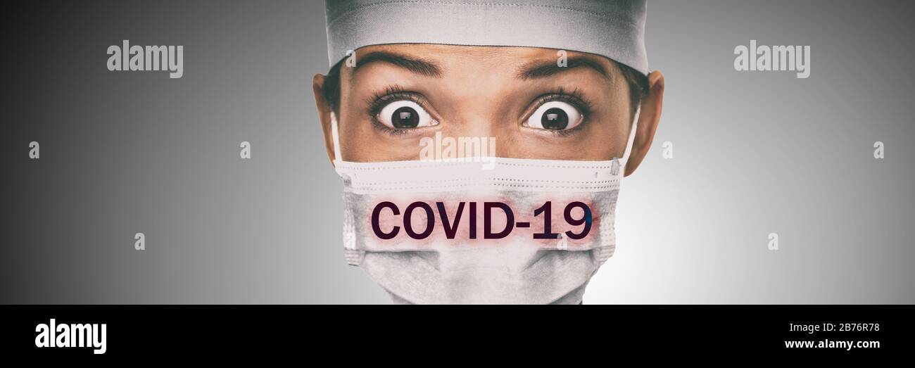 Covid-19 coronavirus text written over doctor surgical face mask Asian woman hospital worked scared shocked by Corona virus pandemic worried. Title on background. Stock Photo