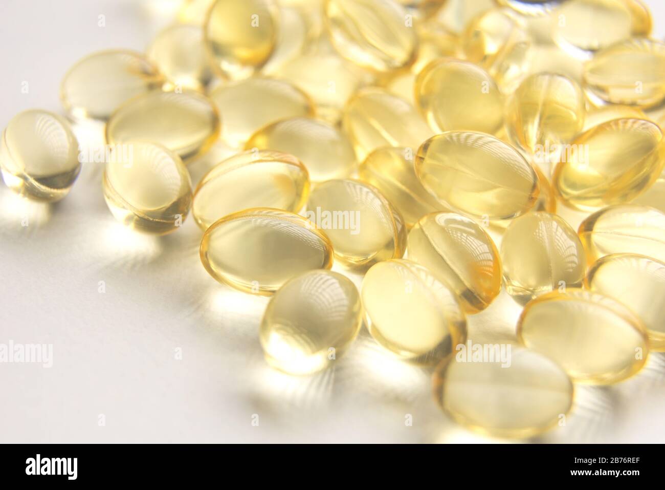 Yellow Gel Capsules on White Background Closeup Stock Photo Alamy