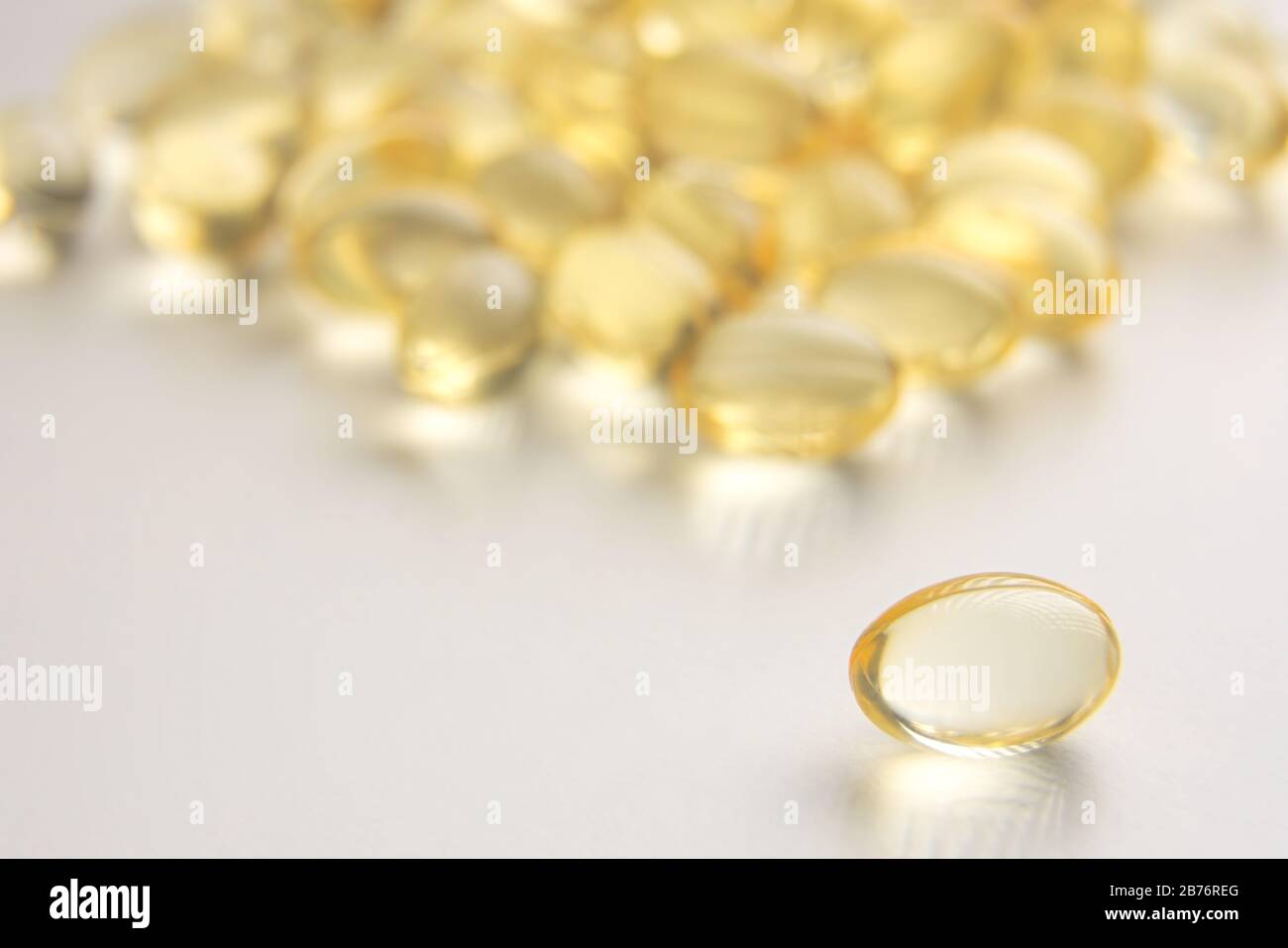 Yellow Gel Capsules on White Background Closeup Stock Photo Alamy
