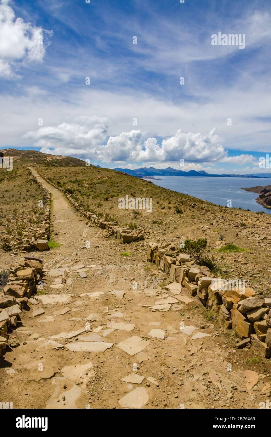 Vertical landscape on Isla del Sol with a blue sky Titikaka Lake and a road Stock Photo