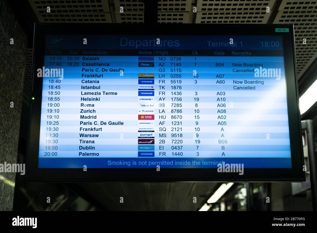 Screen showing flight details following the corona virus outbreak.Due to the rapid spreading of Coronavirus, in Italy many companies cancelled their flights to and from Italy. Few passengers were seen in Malpensa airport wearing facial masks as people working at the airport denounce a worrying situation, showing concerns for their jobs and future. Stock Photo