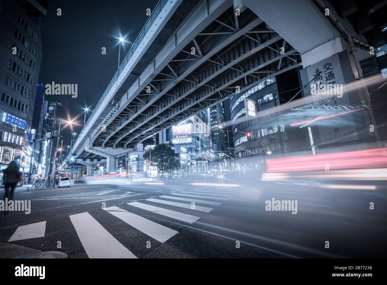 Night long exposure of a pedestrian crossing under an elevated highway ...