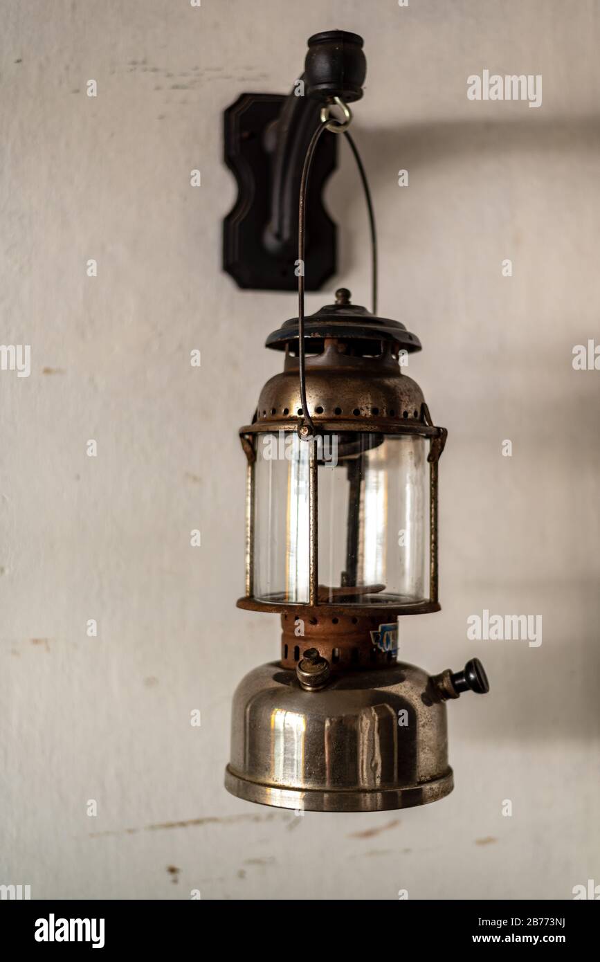 Antique oil lamp hanging on a white wall Stock Photo Alamy