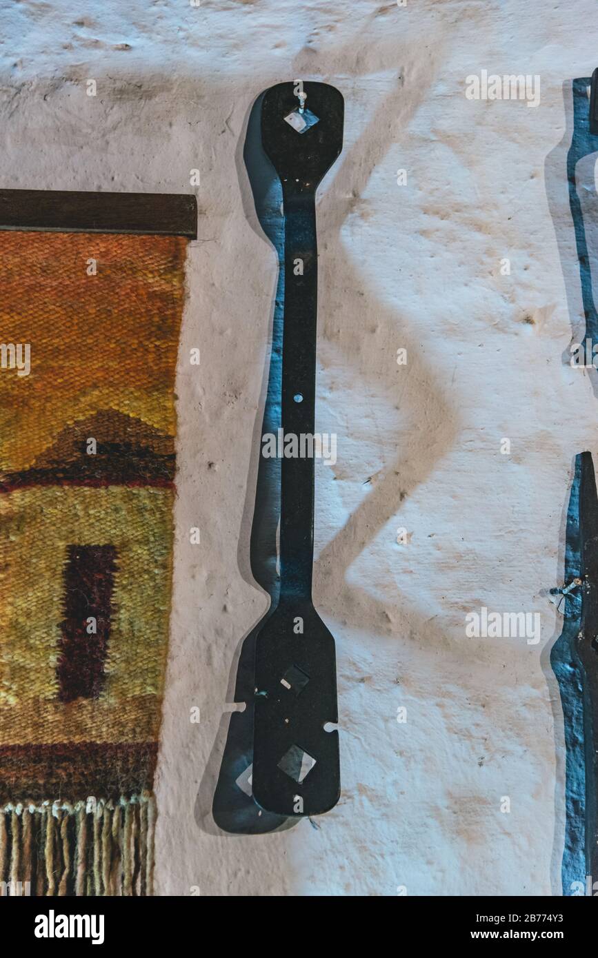 Iron tools hanging on a white wall Stock Photo