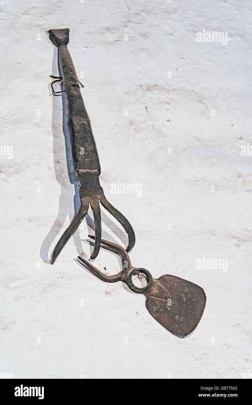 Pitchfork hanging on a white wall Stock Photo