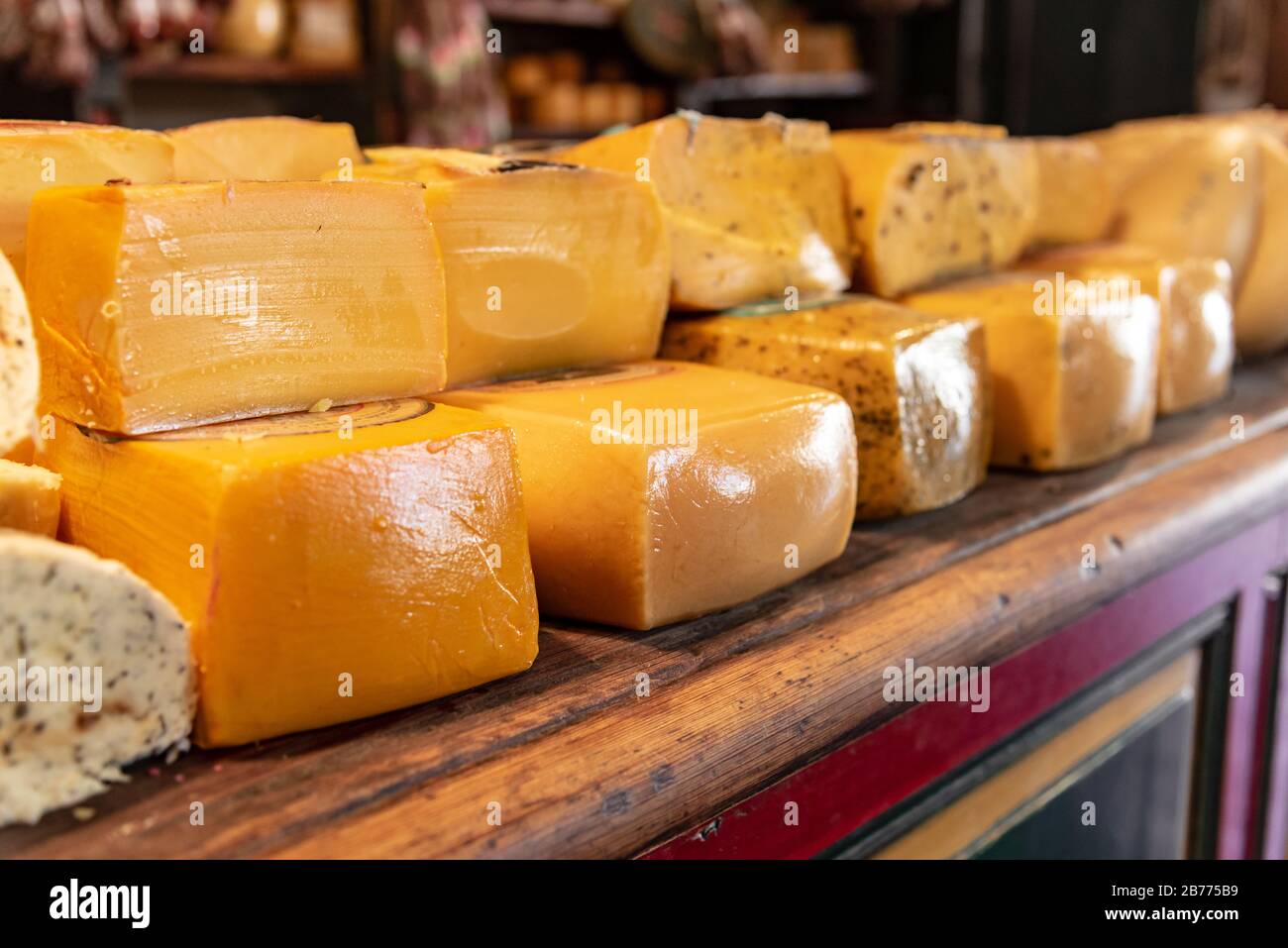Different sort of cheeses on a wooden board for sale Stock Photo