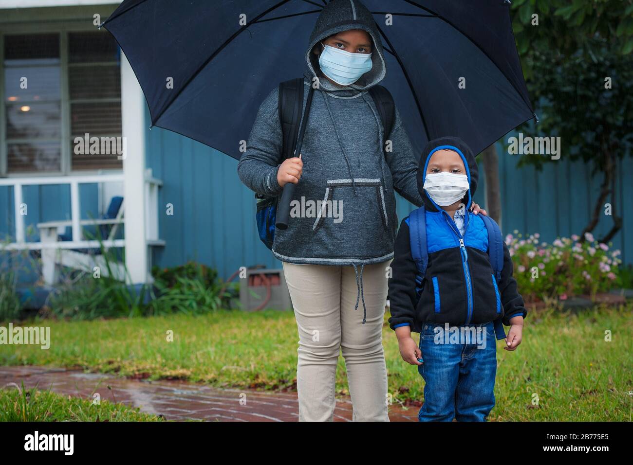 3rd grade student and elementary student wearing medical face mask during coronavirus pandemic. Stock Photo