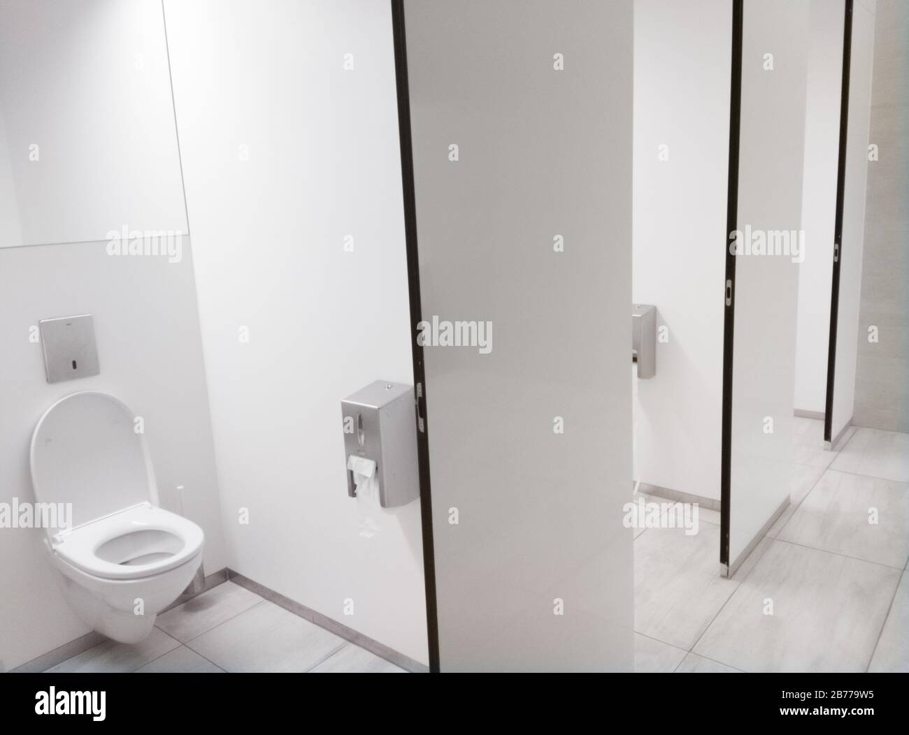 Public bathroom with white toilet seats Stock Photo Alamy