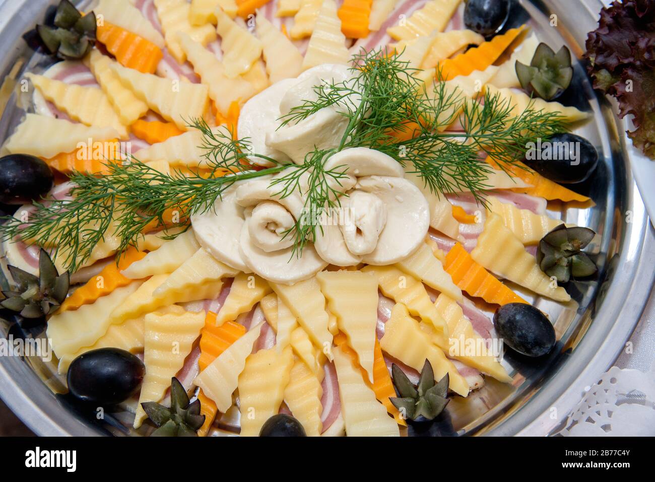 Different types delicacies of meat and cheese arranged in a plate over ...