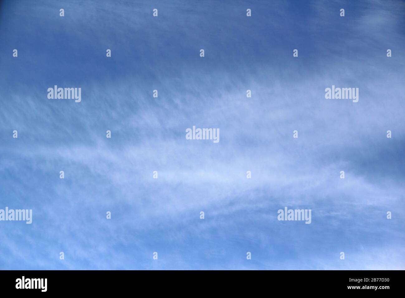 Cloudy blue sky with white and gray clouds. Background for text and