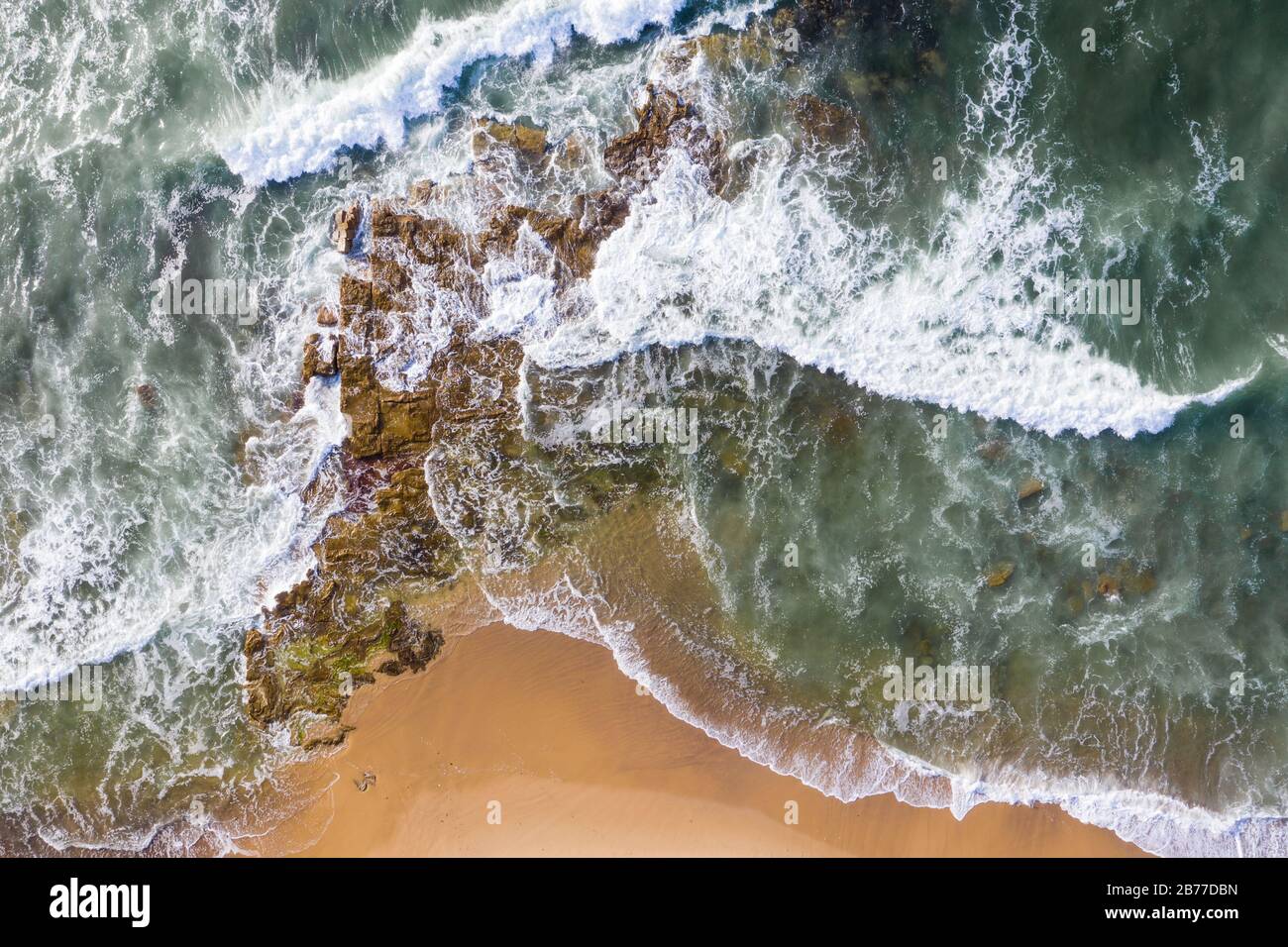 Aerial view of waves breaking onto rocks at Dudley Beach Newcastle