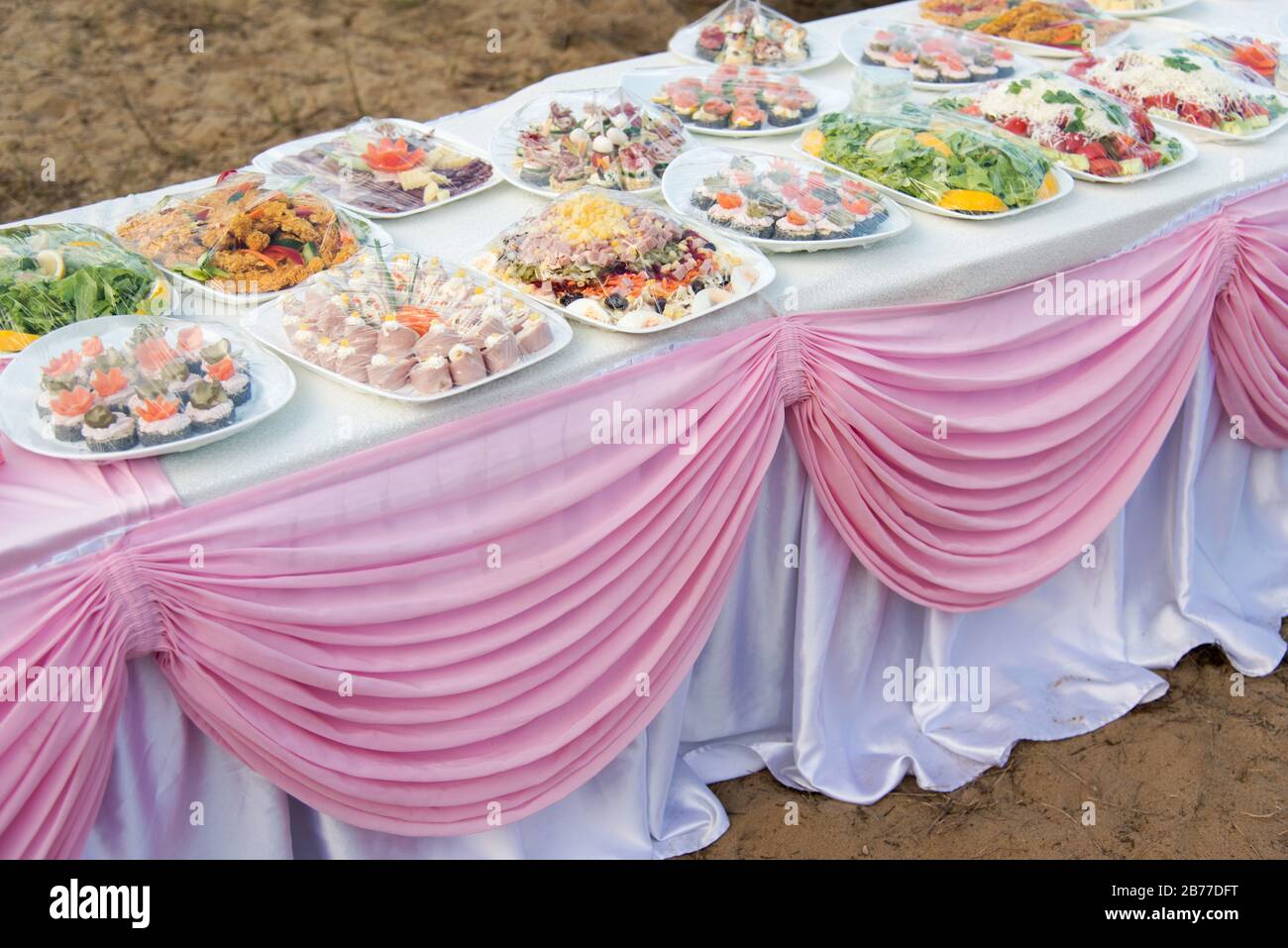 Buffet catering for a wedding party on the beach on a white table