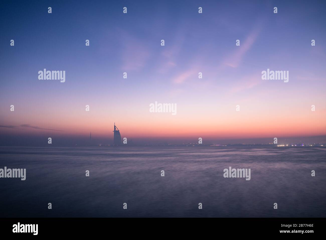 Dawn colors over the Dubai Jumeirah disctrict cityscape on a hazy day. Palm Jumeirah, Dubai, United Arab Emirates. Stock Photo