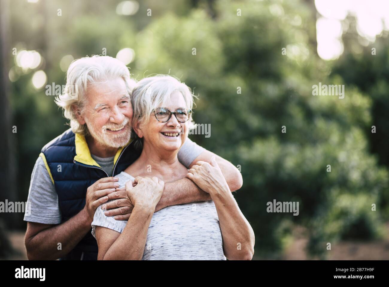 Old mature retired senior people smile and enjoy the love couple during  outdoor leisure activity together - green forest and wood in background for  en Stock Photo - Alamy