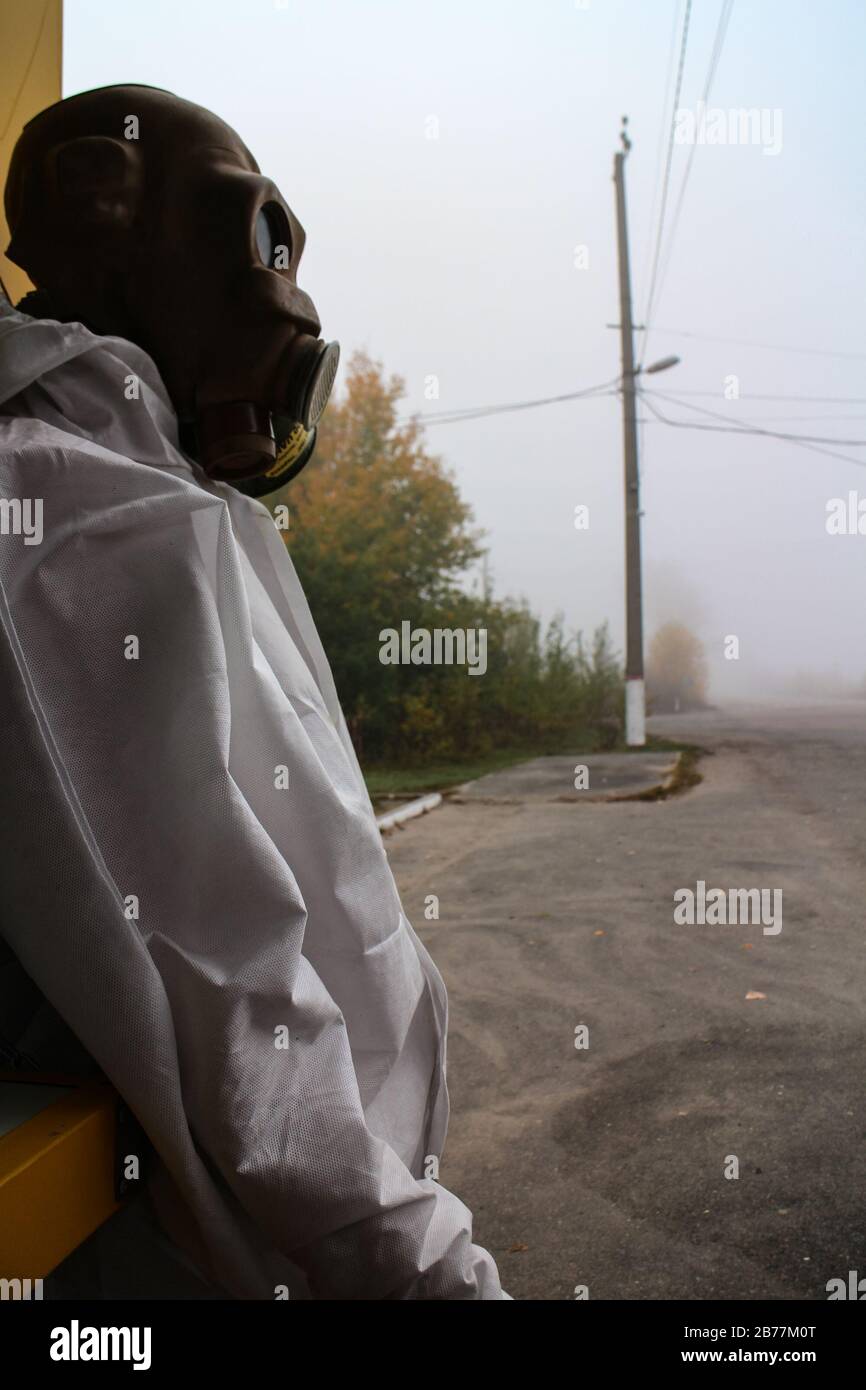 Mannequin wearing a protective suit and old soviet gas mask on sale at a souvenir shop on a misty morning in the Chernobyl exclusion zone in Ukraine. Stock Photo