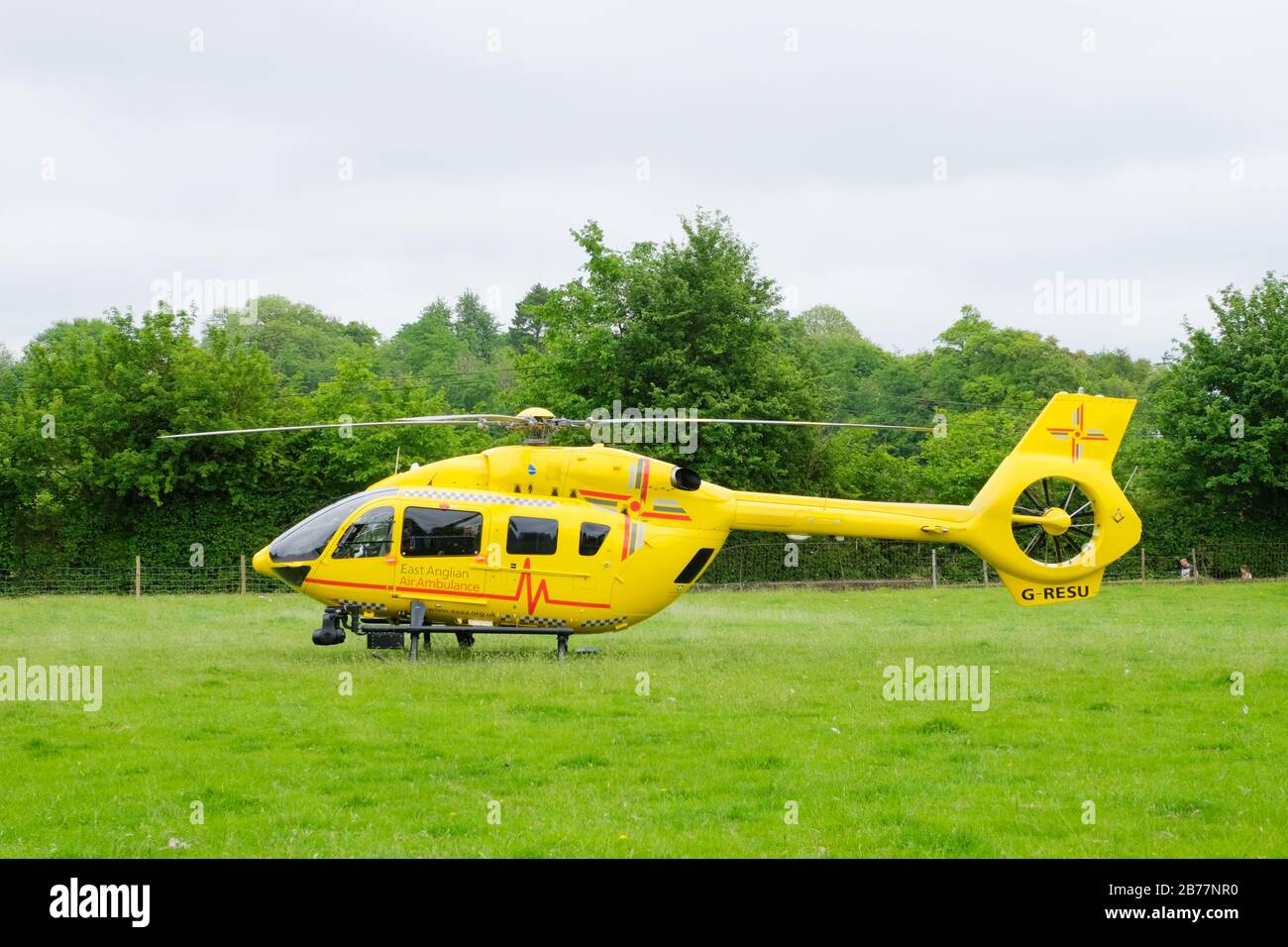 East Anglian Air Ambulance helicopter attending emergency in Much Hadham, Hertfordshire. UK Stock Photo