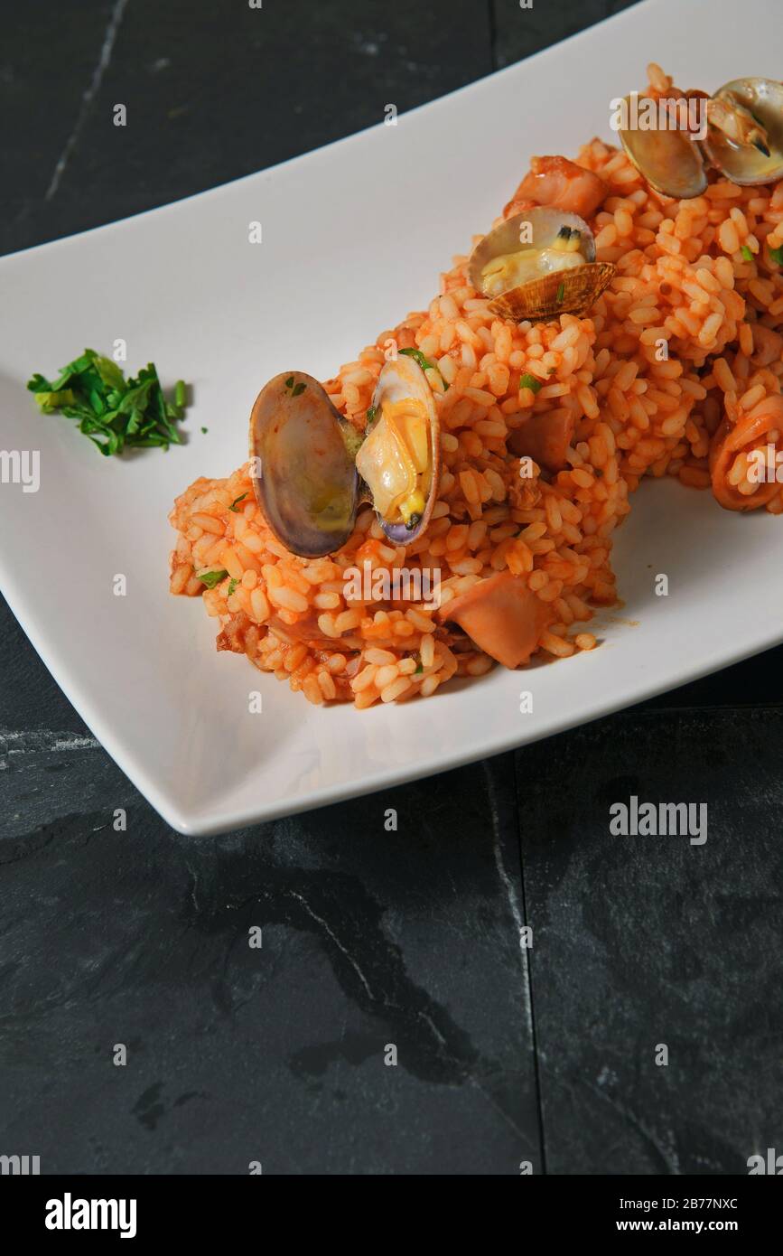 Seafood risotto Typical italian rise with tomato sauce and seafood