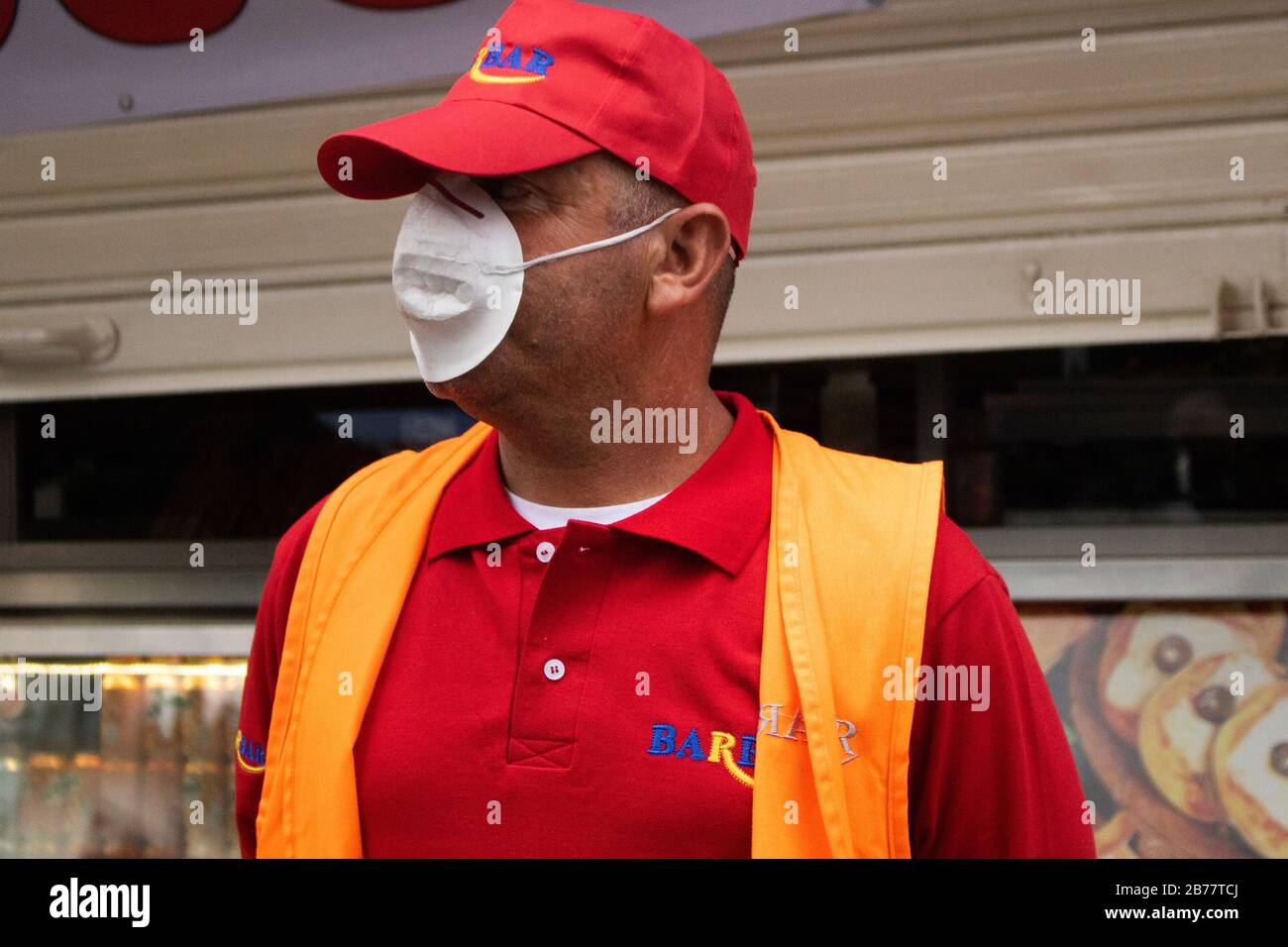 BEIRUT, LEBANON. 14 March 2020.  A man working for a fast food restaurant in Hamra Street Beirut wearing a protective face mask against covid 19 novel coronavirus during the ongoing coronavirus health crisis. Credit: amer ghazzal/Alamy Live News Stock Photo