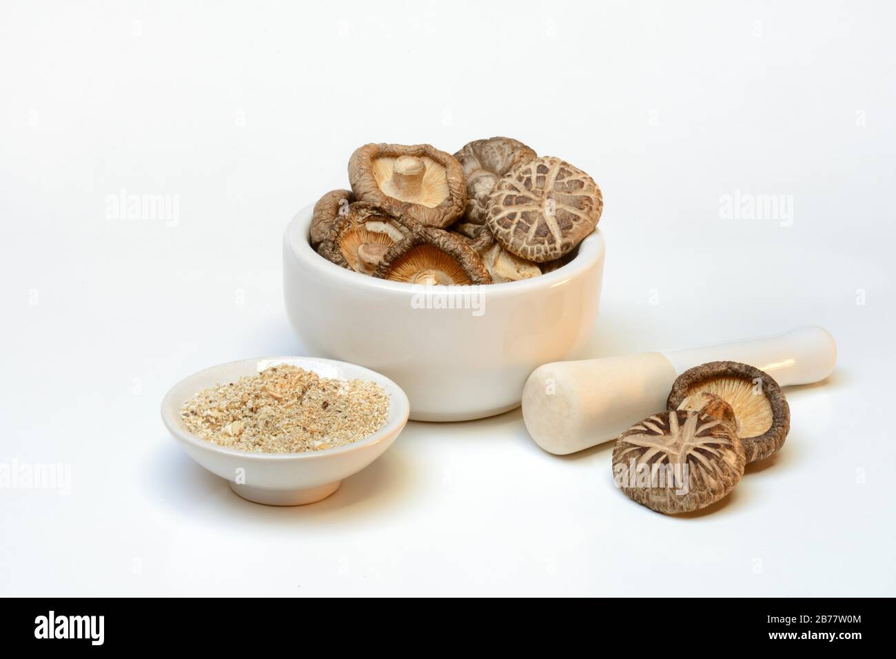 Dried shiitake mushrooms in a grating bowl and shiitake powder in small