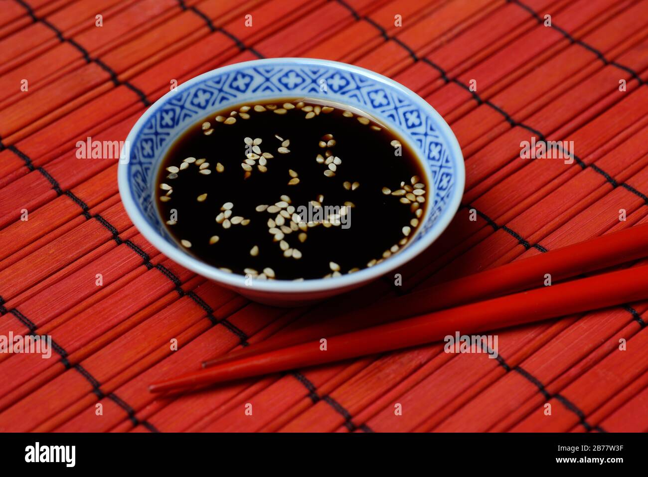 White sesame seed with soy sauce in small bowl hires stock photography