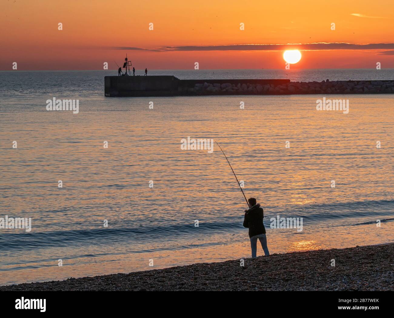Sea fisherman at sunset Stock Photo