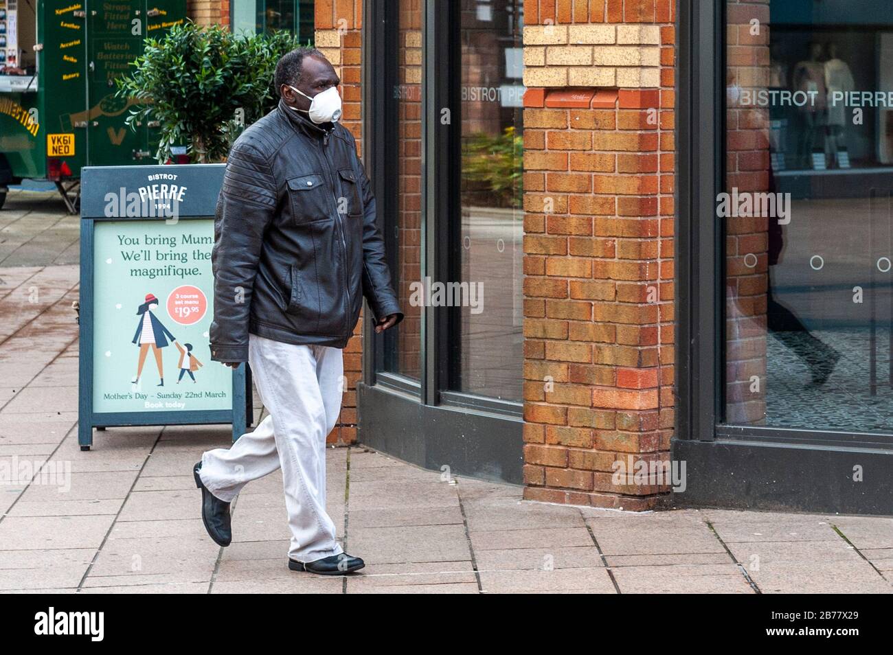 Coventry, West Midlands, UK. 14th Mar, 2020. The Coronavirus pandemic, or Covid-19, forced shoppers to wear protective masks in an almost deserted Coventry city centre this morning. Credit: Andy Gibson/Alamy Live News Stock Photo