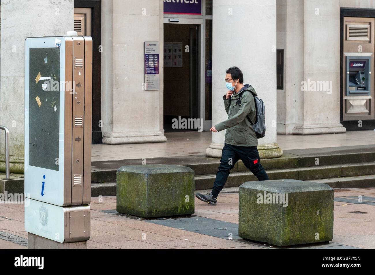Coventry, West Midlands, UK. 14th Mar, 2020. The Coronavirus pandemic, or Covid-19, forced shoppers to wear protective masks in an almost deserted Coventry city centre this morning. Credit: Andy Gibson/Alamy Live News Stock Photo