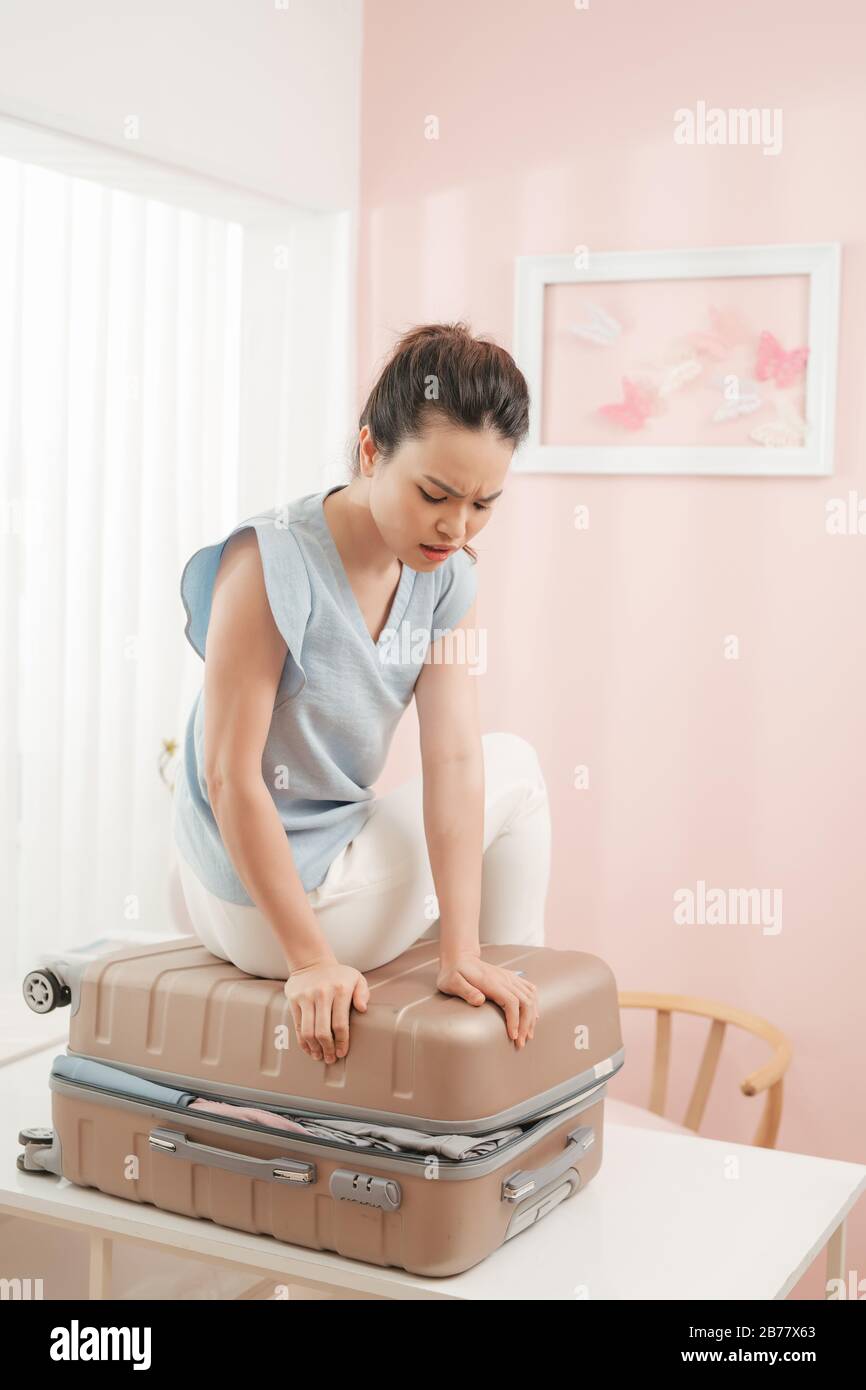 Calm woman packing luggage in bedroom · Free Stock Photo