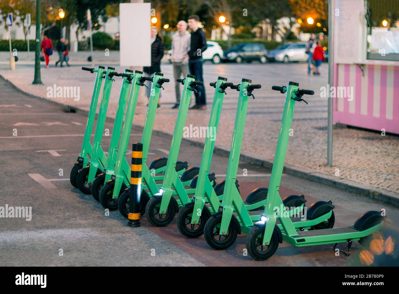 Green electric scooters for rent parked on the city Stock Photo - Alamy