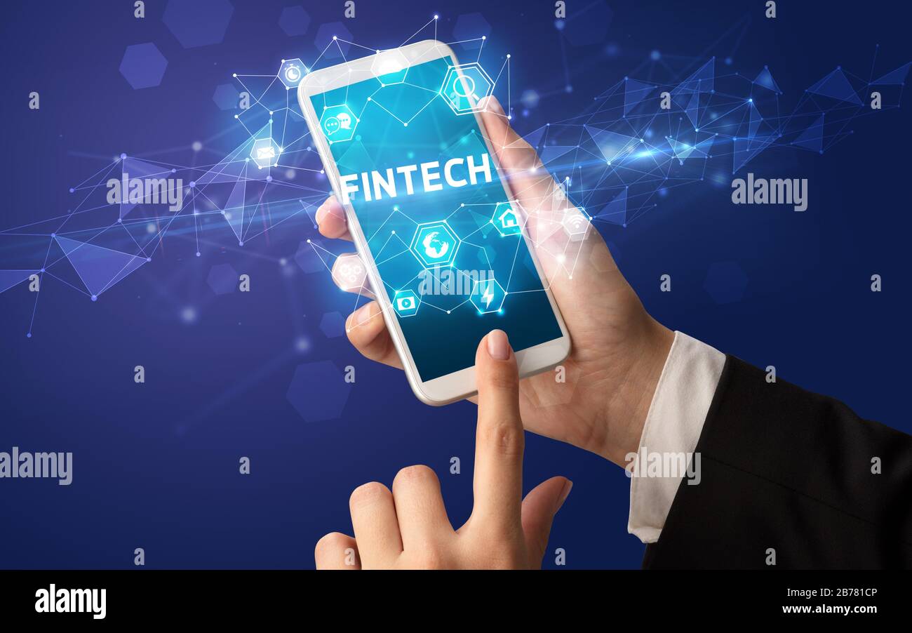 Female hand holding smartphone with FINTECH inscription, modern technology concept Stock Photo