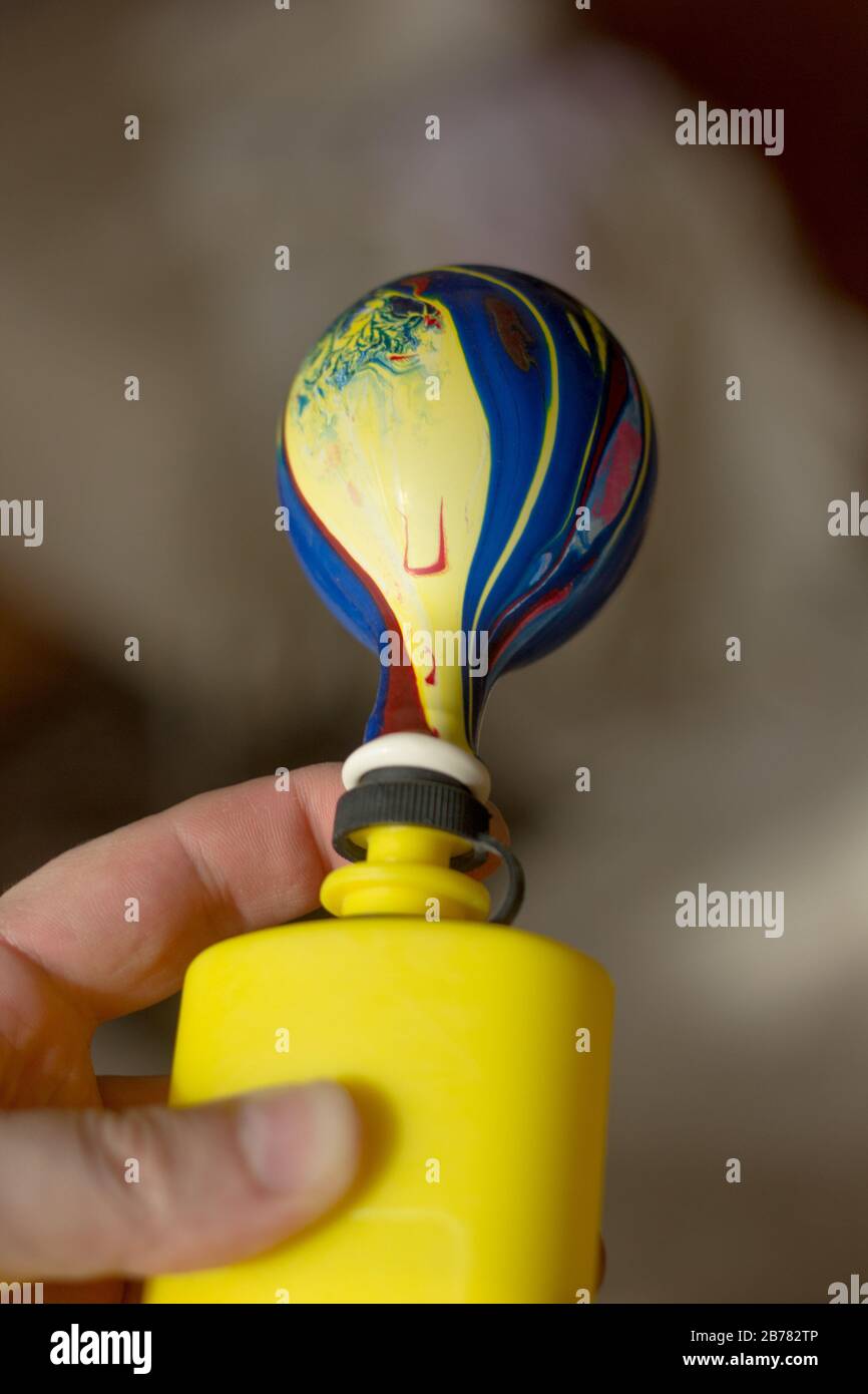 Blowing up balloon with the plastic pump Stock Photo Alamy