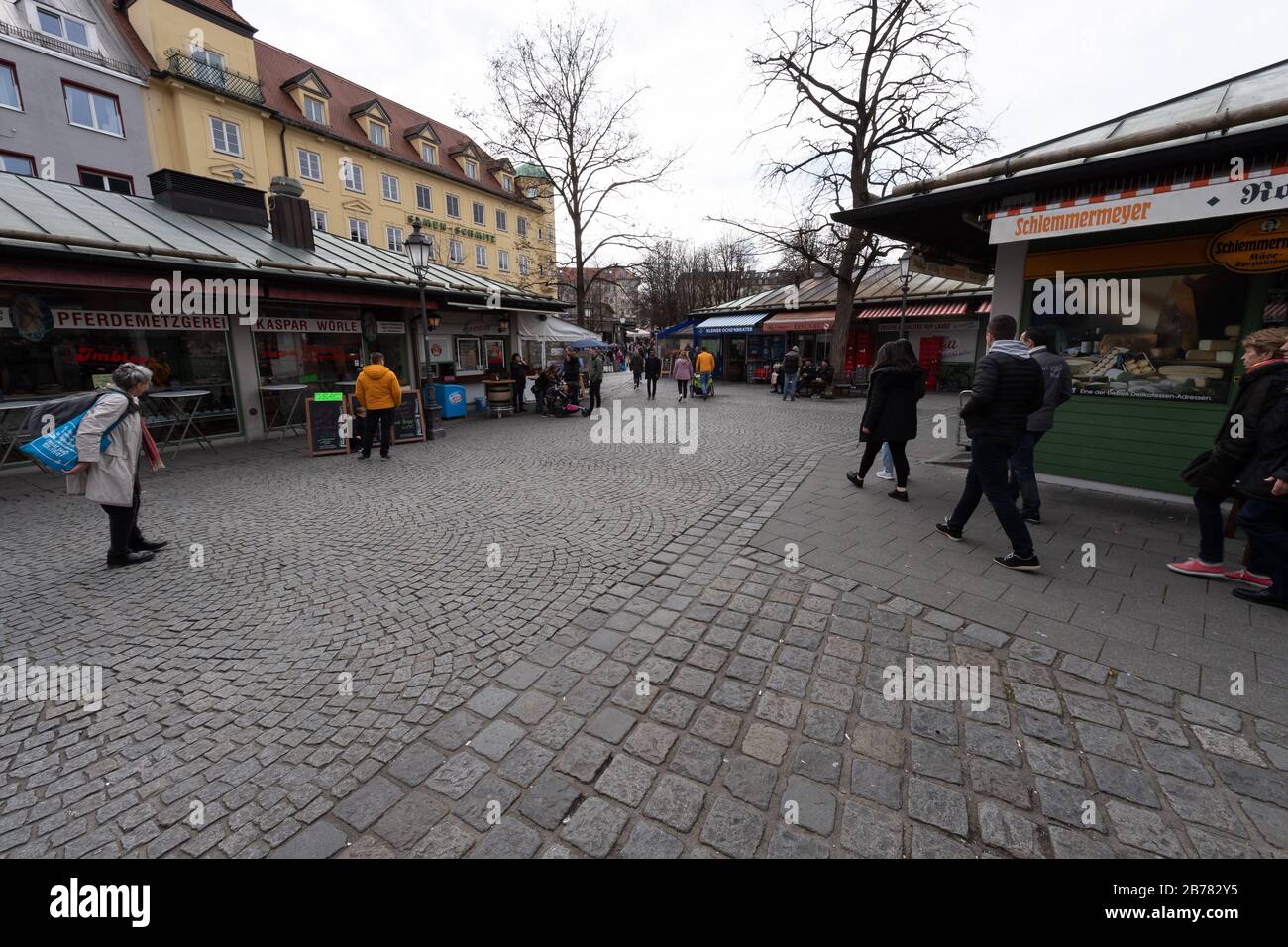 Munich, Germany. 14th Mar, 2020. The Viktualienmarkt, which is otherwise well attended at lunchtime, is only slightly frequented. Credit: Peter Kneffel/dpa/Alamy Live News Stock Photo
