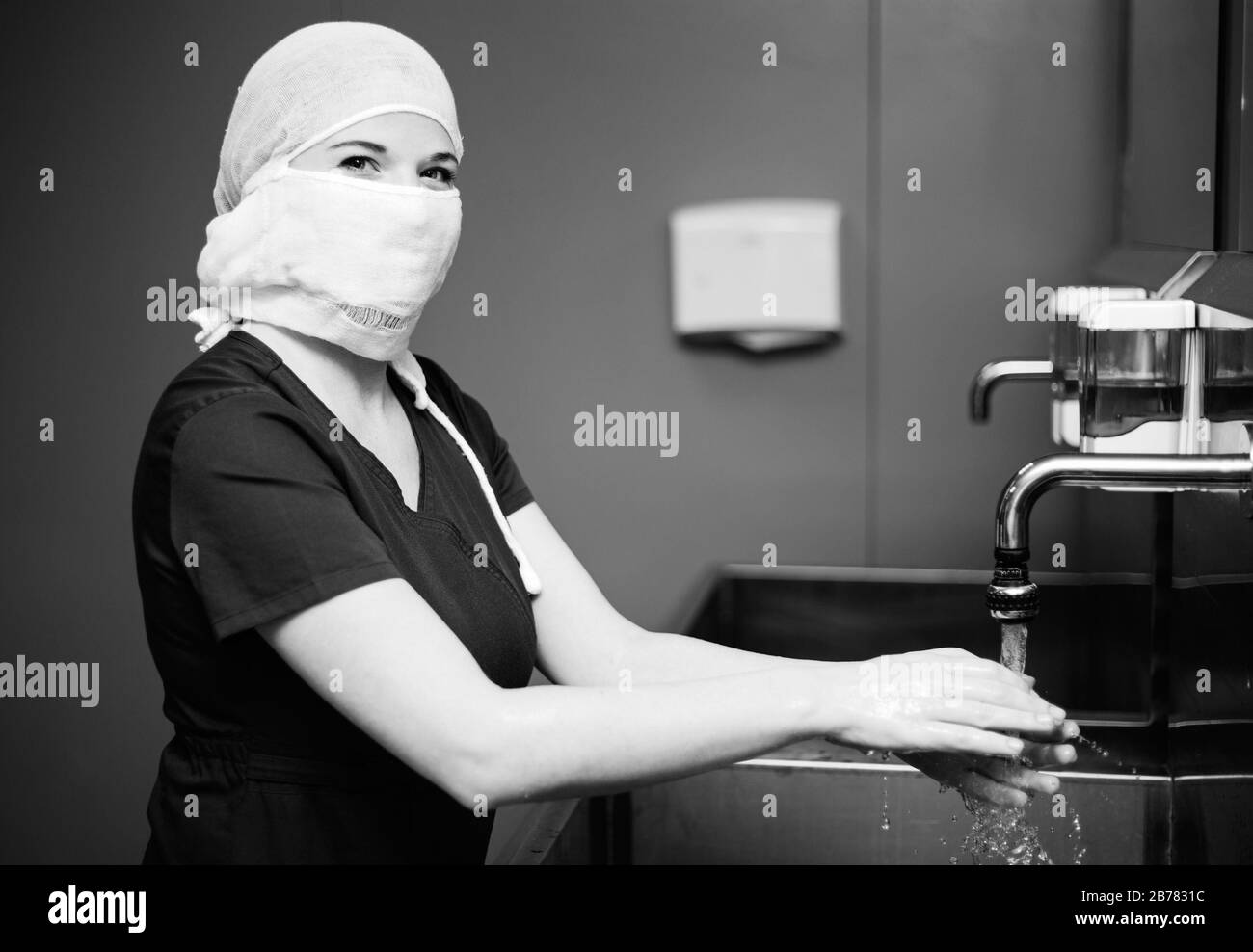 Nurse in protective medical mask washes hands Stock Photo