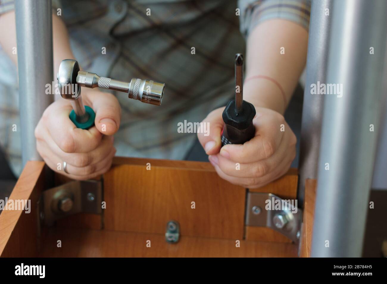 Socket wrench and screwdriver in a hands of workman Stock Photo Alamy