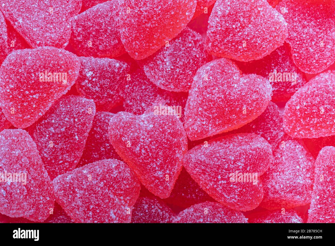 Pink jelly candy hearts with sugar, full frame background. Swedish
