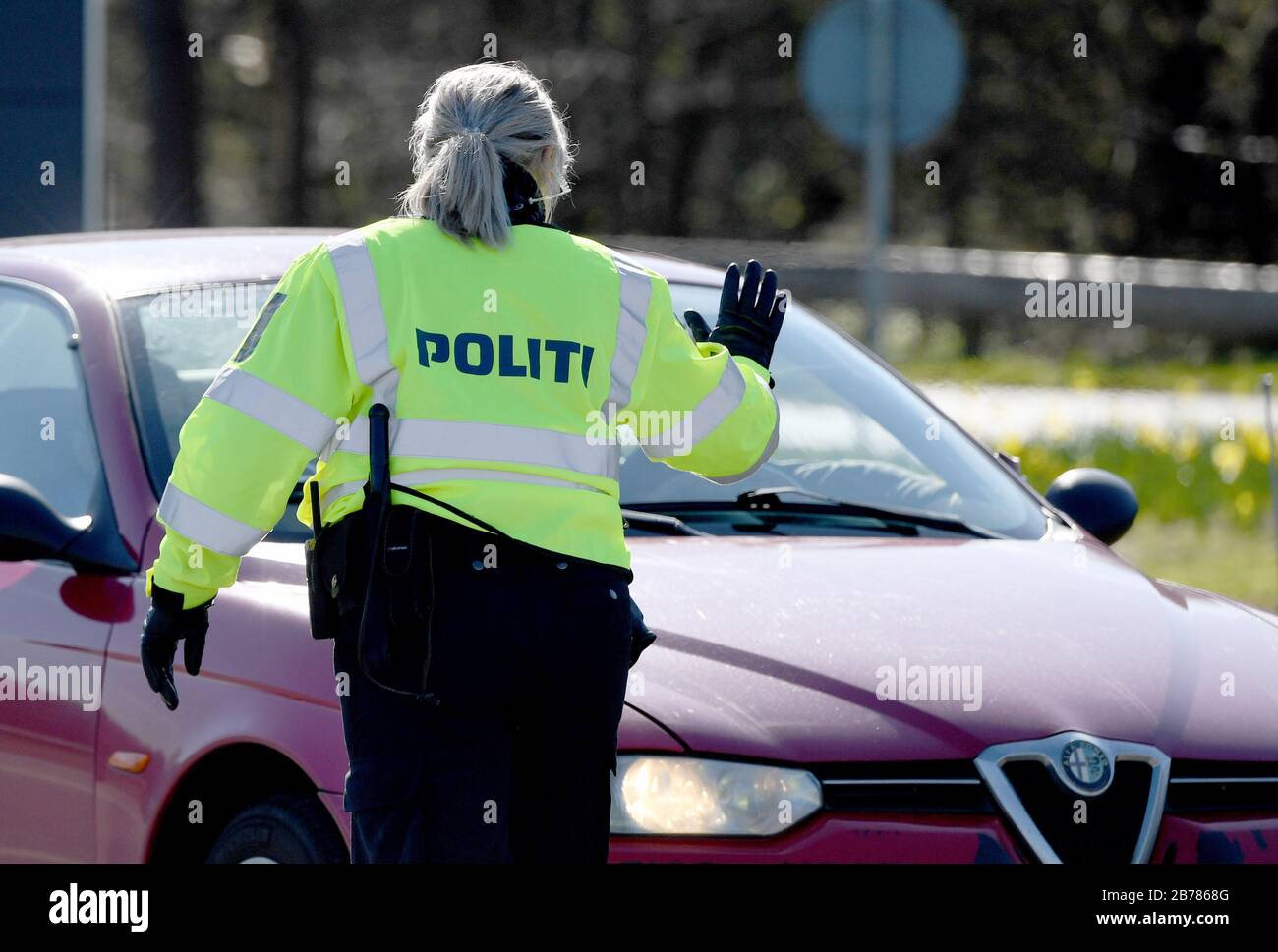 Flensburg, Germany. 14th Mar, 2020. Police officers check vehicles