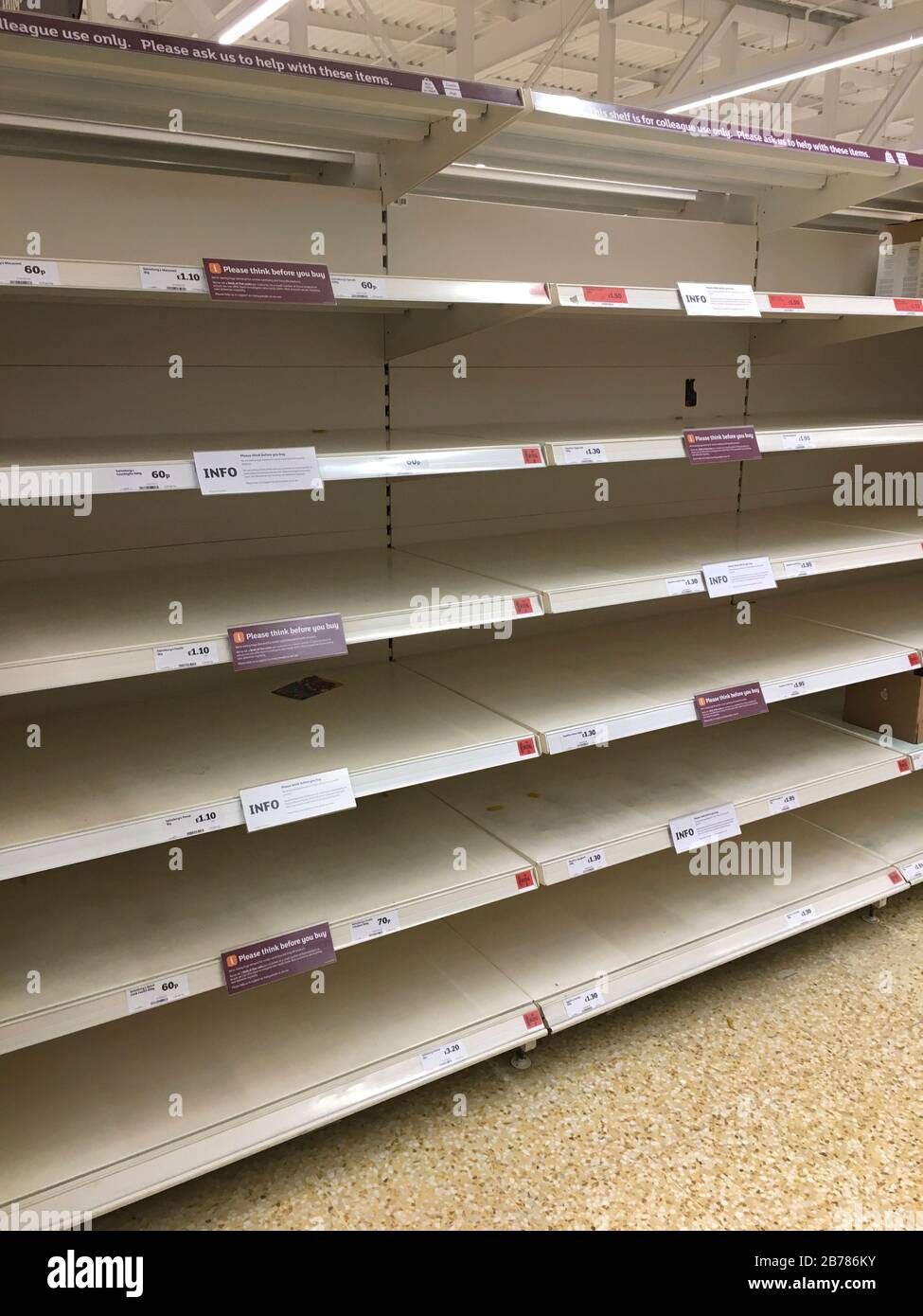 Empty supermarket food shelves in Godalming, Surrey, England. The spread of Coronavirus- Covid 19 has seen dried pasta stocks diminish rapidly. Stock Photo